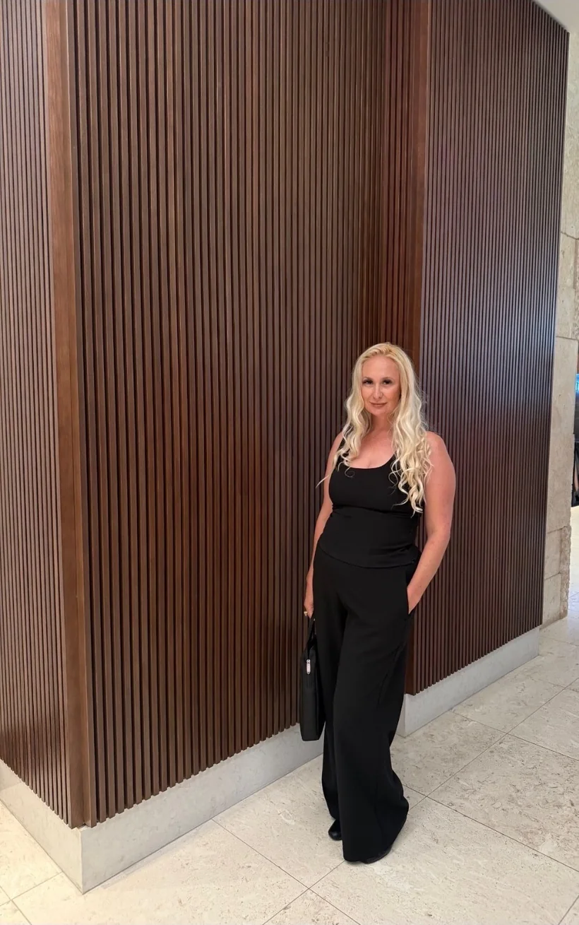 Kelly in a black outfit in a modern interior